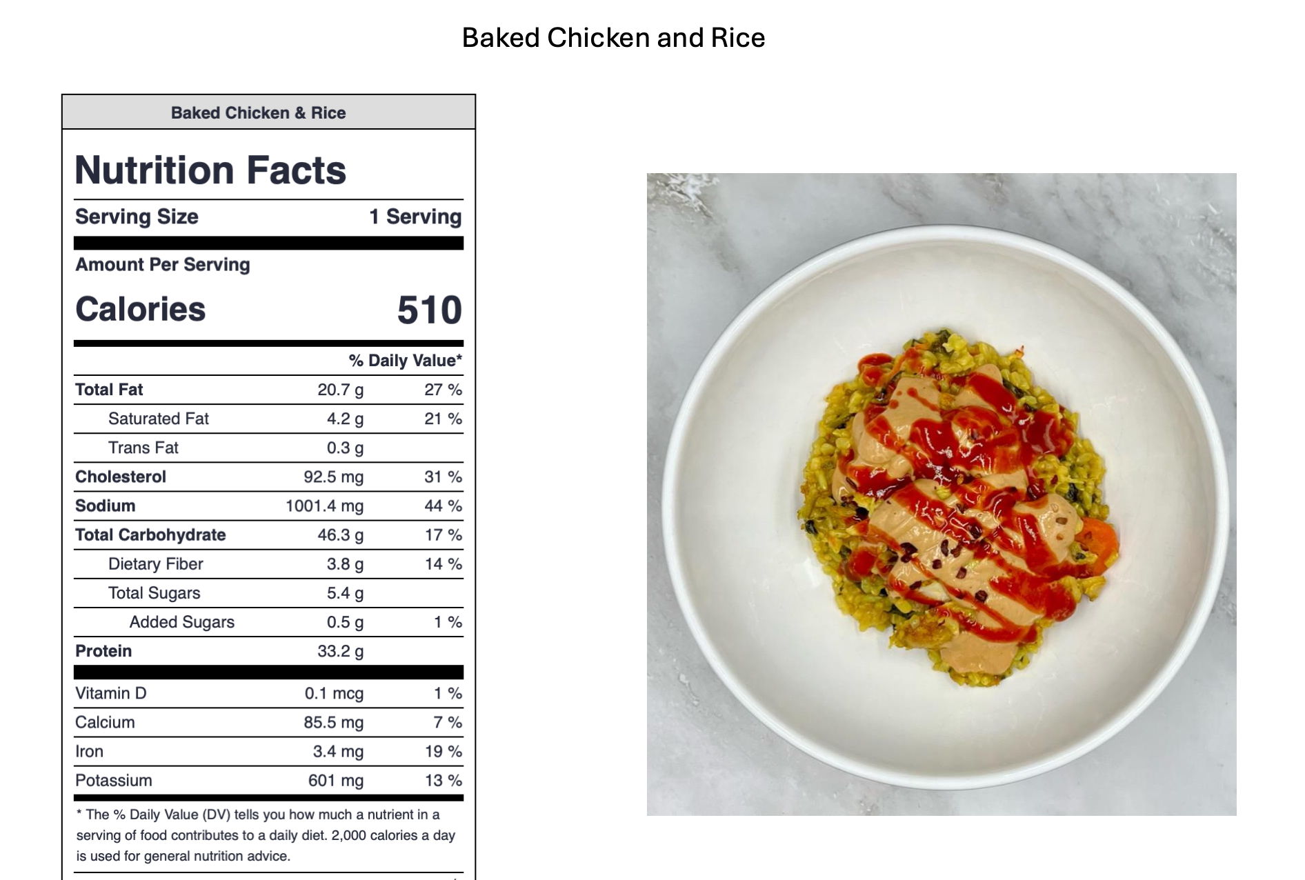 A bowl of baked chicken and rice topped with ketchup, served on a marble surface.