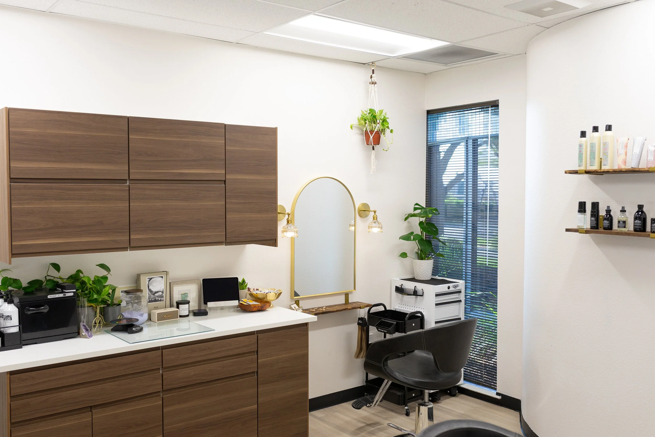 Modern hair salon interior with styling stations, mirrors, and chairs