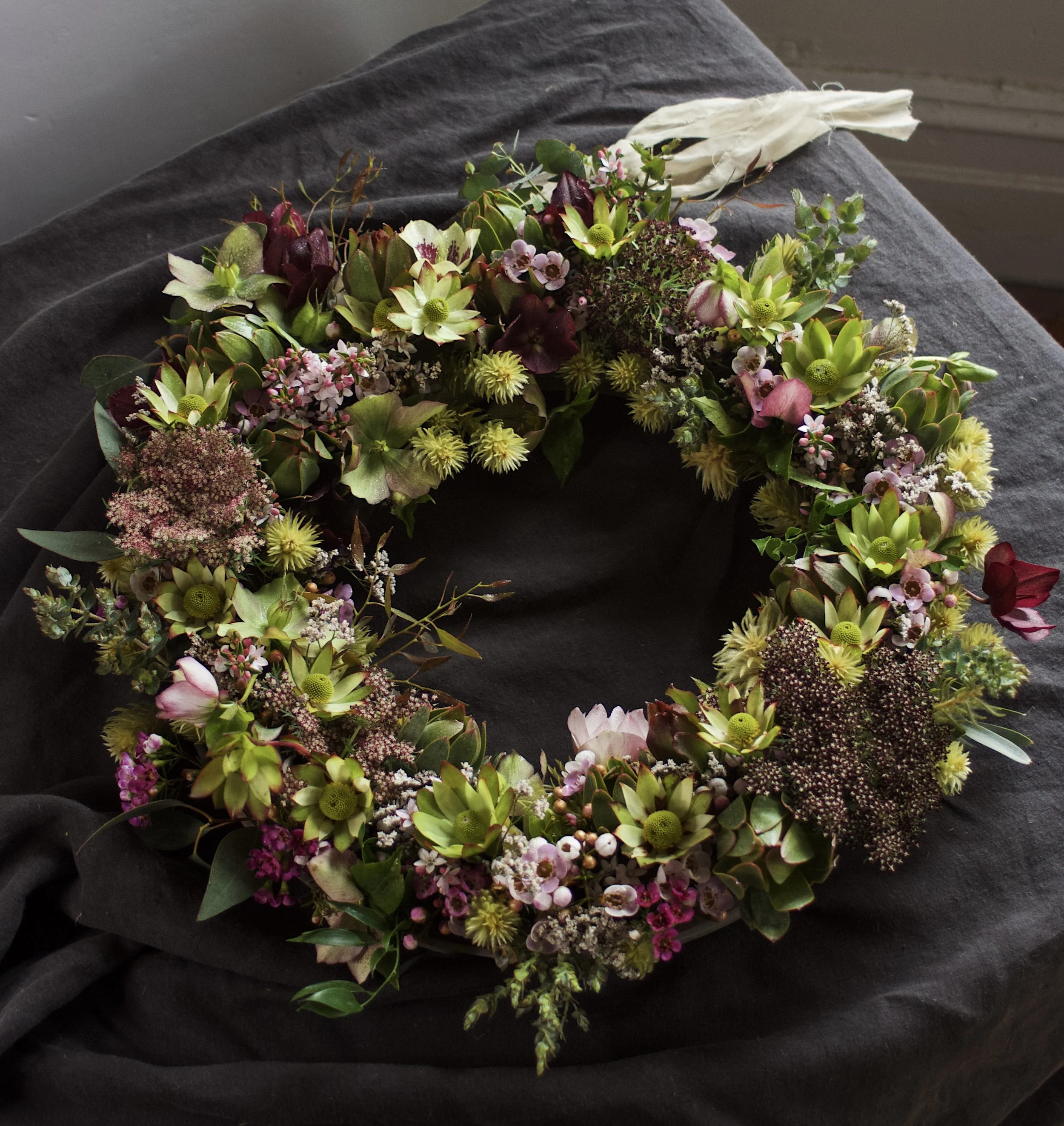 Native garden-style funeral wreath handcrafted with fresh seasonal Australian flowers by Pash Flowers, Melbourne florist specialising in bespoke farewell tributes.