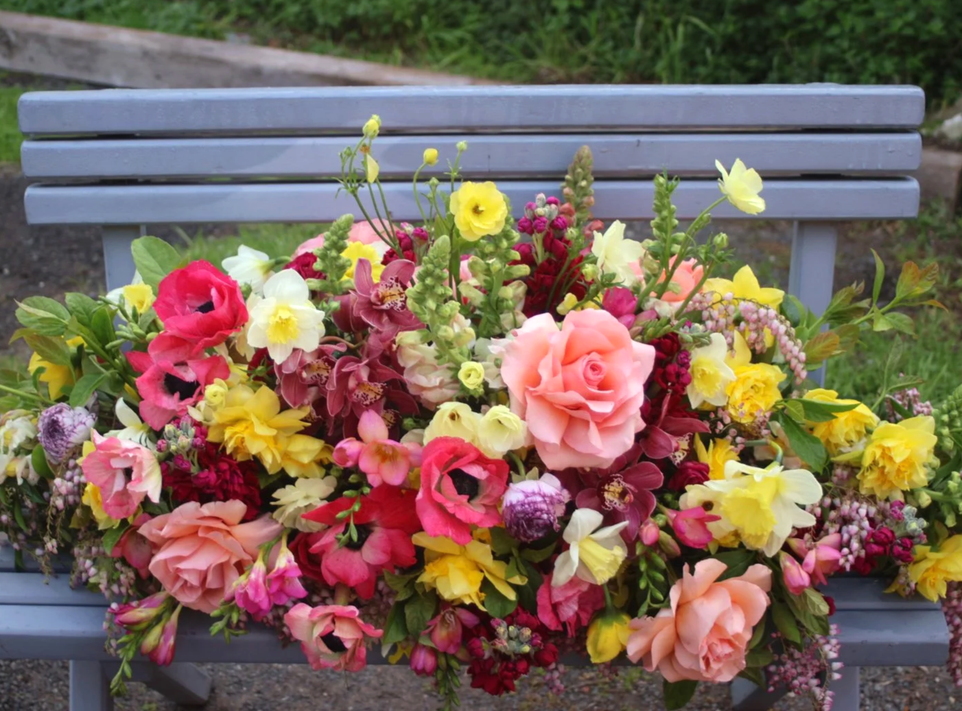 Bespoke bright funeral casket spray handcrafted by Pash Flowers, Melbourne florist specialising in elegant farewell flowers.