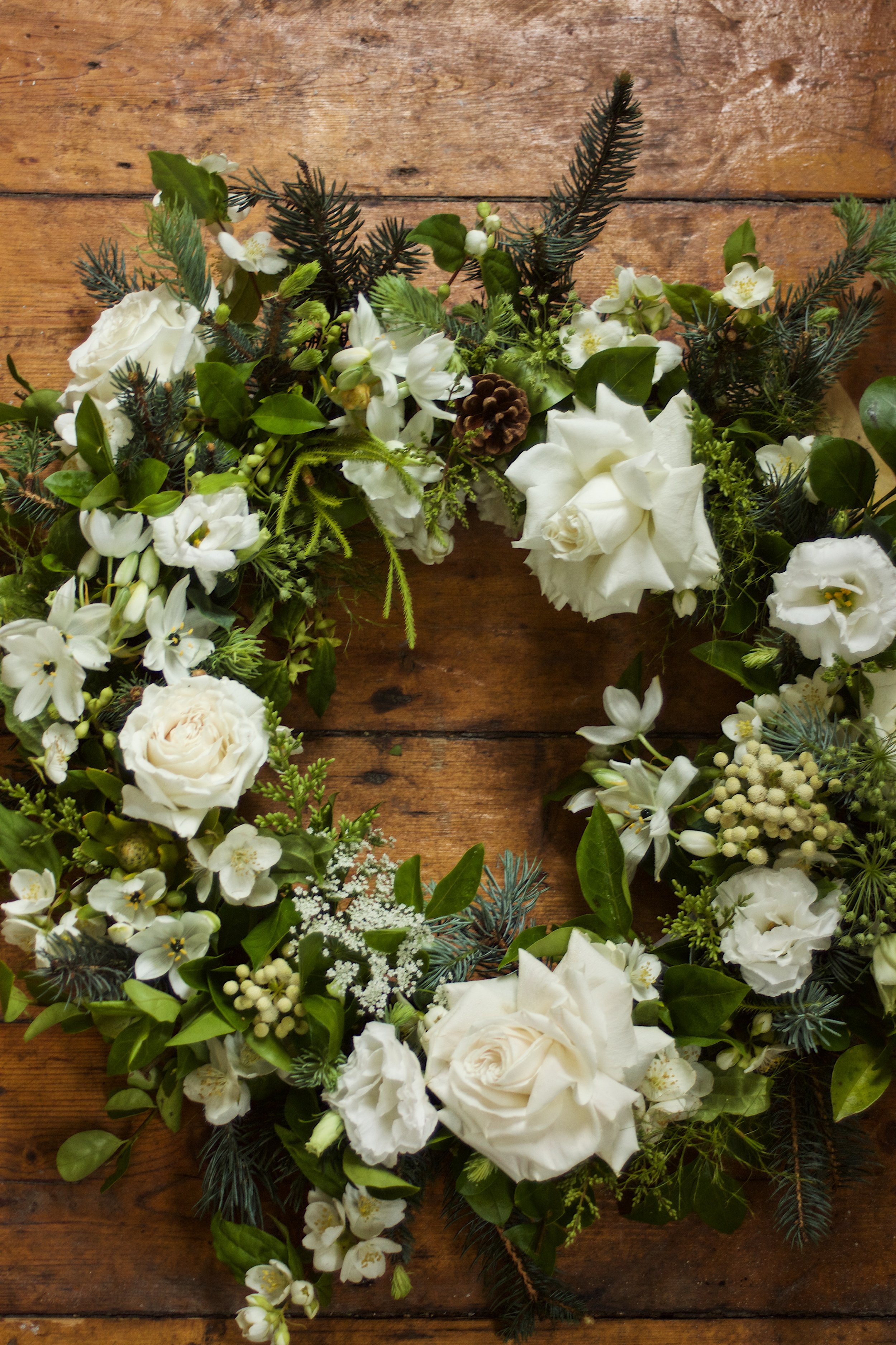 Elegant white and green funeral wreath handcrafted with fresh seasonal flowers by Pash Flowers, Melbourne florist specialising in bespoke farewell tributes.