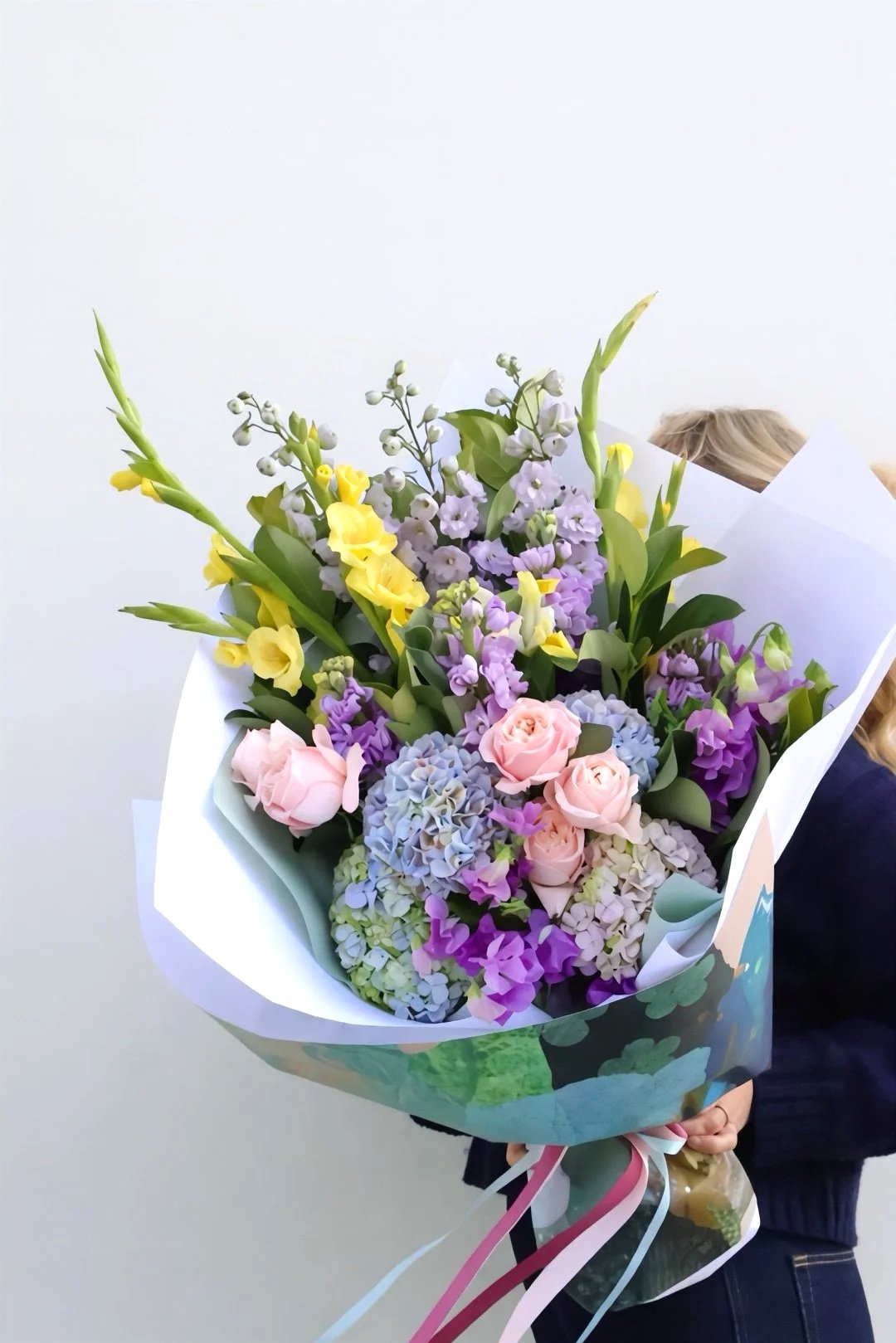 Wrapped in Pash florist's choice bouquet with fresh seasonal flowers in exclusive Leanne Daquino Art wrapping by Pash Flowers Brighton.