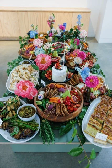 Grazing table styled with colourful seasonal event flowers by Pash Flowers Melbourne