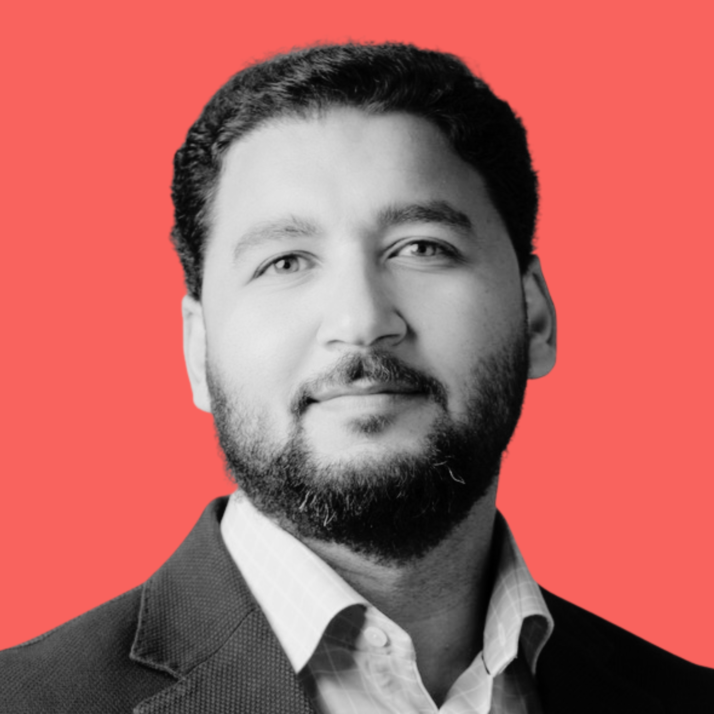 Black and white portrait of a bearded man in a suit.