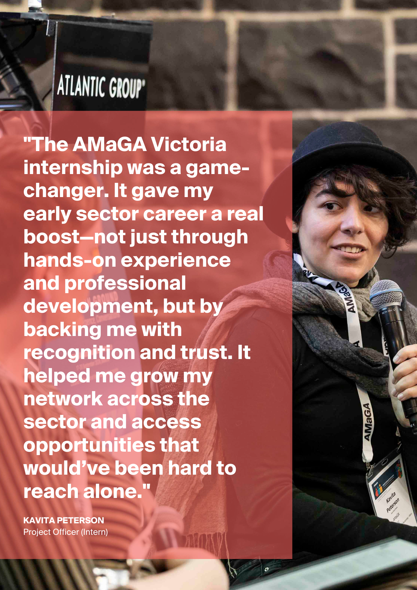 Two individuals sitting, facing each other. The person on the right is holding a microphone in their hand.