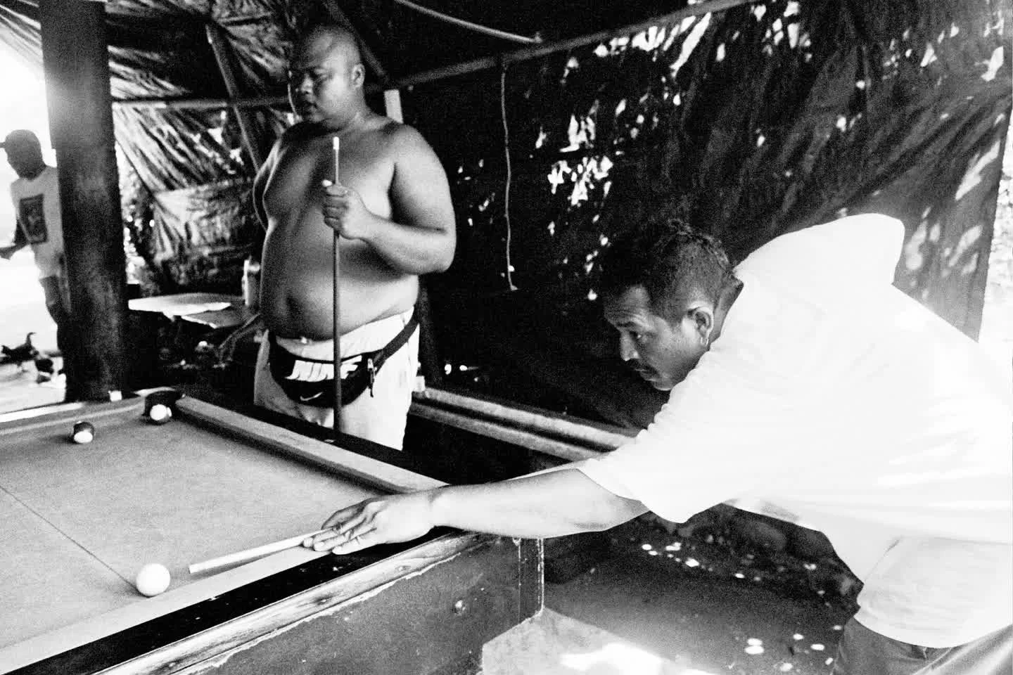 There's something about a pool table that invites both tension and camaraderie.
In this second frame of our "Pot Black" series, a local legend lines up his shot with quiet focus while the bar hums around him.

Shot on TRI X 400, this photo 
