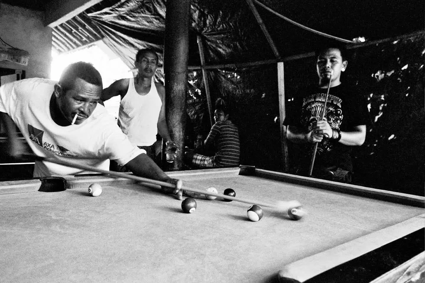 Sometimes the best portraits are unplanned.

Caught between turns, drink in hand, cue resting nearby &mdash; this image is a pause in motion. The rice wine flows, laughter rises, and the night leans in.

We love how film picks up textures in these qu