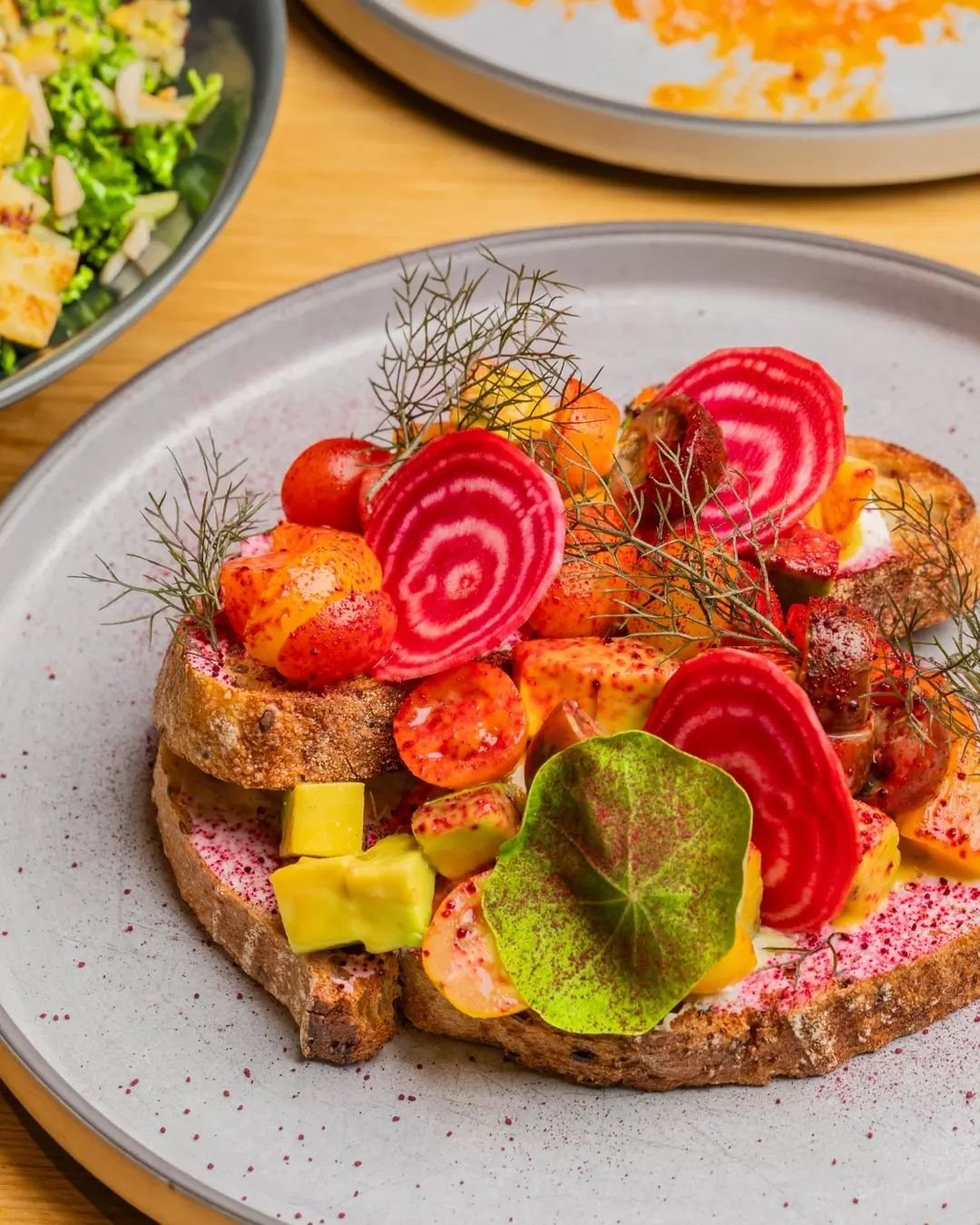 Meet our Avocado Toast, 2.0: now a stack of labneh, diced avocado, burnt orange, cherry tomatoes &amp; heirloom beets, beautifully presented on grain toast and finished with soft herbs. 🌿 🥑

Are you adding a poached egg, smoked salmon or bacon on t
