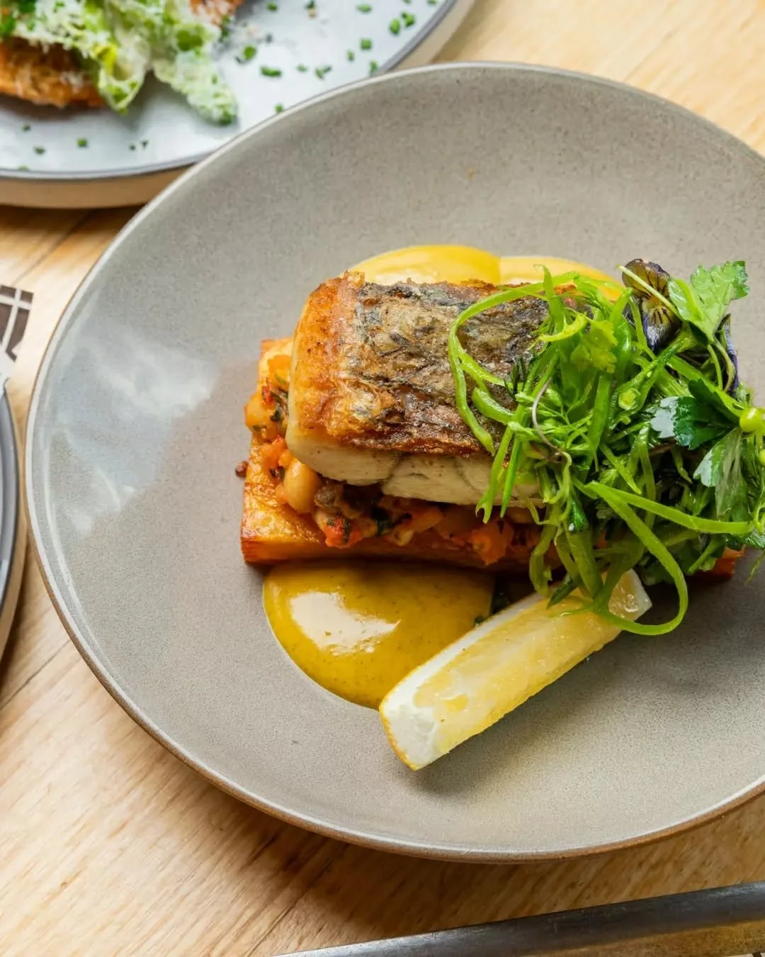 Fresh, vibrant and full of flavour. Our Grilled Barramundi is for all the seafoodies out there 🐟 

Crispy skin barramundi served with potato galette, tomato and white bean salsa, soft herbs and batata harra beurre blanc.

Bright flavours. Beautiful 