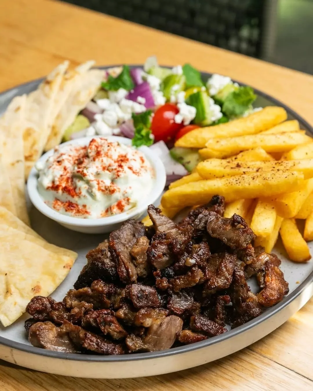 Four hours of slow-cooking, just in time for your Thursday lunch plans. You're welcome 🙏🏼 Schedule in a date with our Open Lamb Souvlaki today, served with creamy tzatziki, warm pita and a bright Greek salad + fries on the side. 🌯