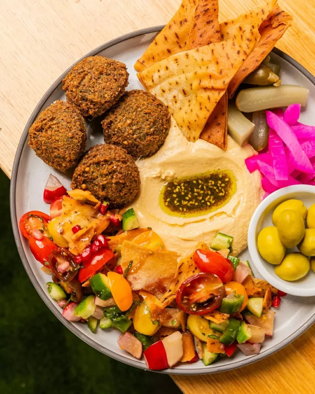 A plate that does it all: crispy housemade falafel, bright fattoush, creamy hummus, olives, pickles and fried pita for dipping.

Light, satisfying and seriously good &ndash; our Falafel Plate has that fresh lunch energy, with an extra zing of colour 