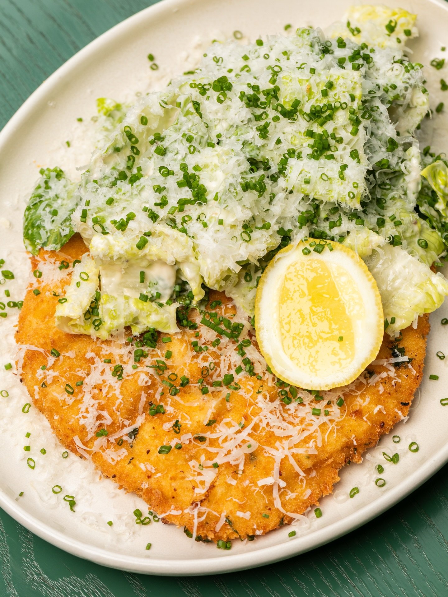 Comfort food, with extra crunch. Detour to Friction en route to tomorrow&rsquo;s plans, for a serve of our golden house-crumbed chicken schnitzel, topped with crisp cos, parmesan, Caesar dressing and fresh chives. 🤌🏼