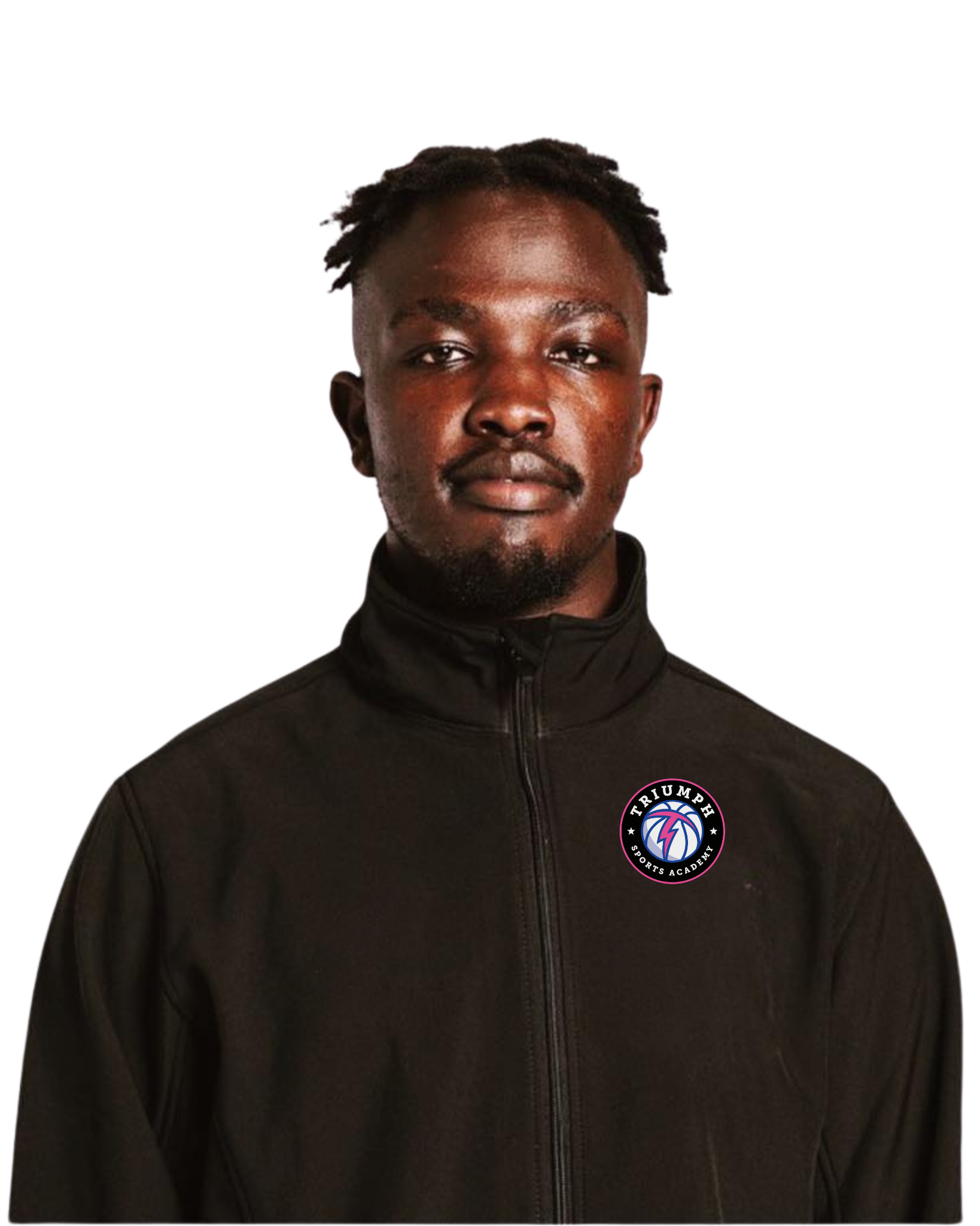 A young man with dark skin and dreadlocks, wearing a black jacket with a 'Triumph Sports Academy' logo on the chest, standing against a black background.