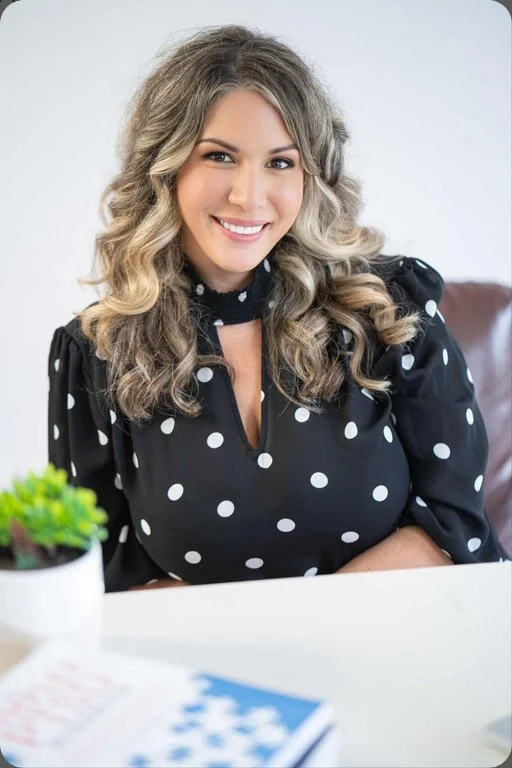 Woman at desk in polka dot shirt
