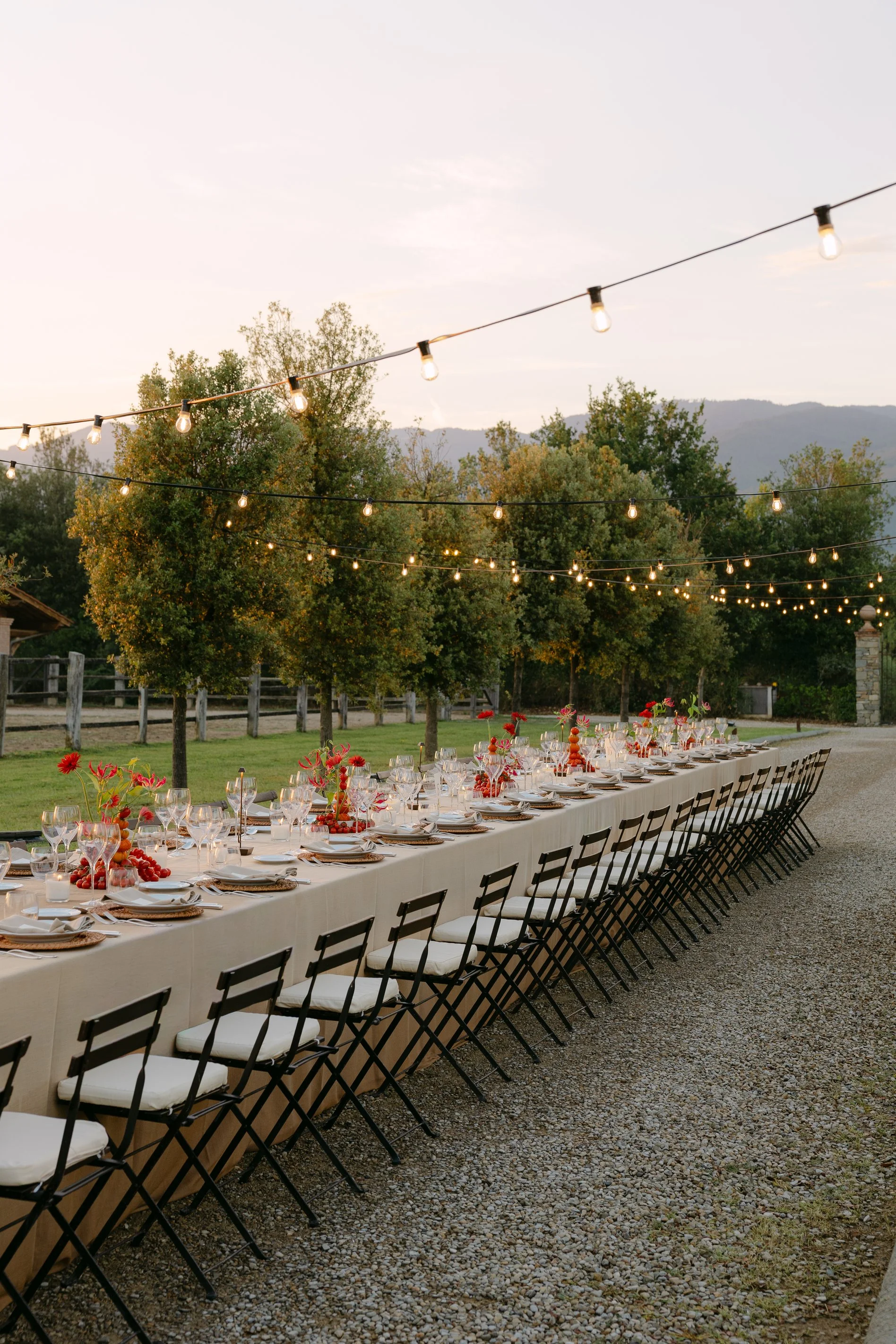 Long candlelit dinner table at Il Borro during a destination wedding weekend