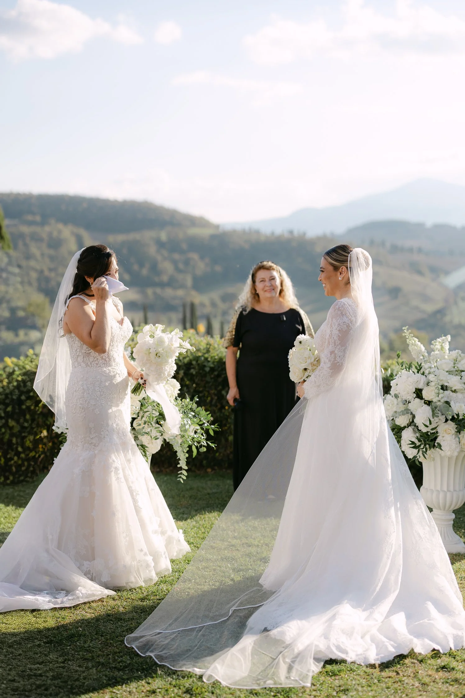 Two brides exchanging vows during a same-sex ceremony in Tuscany.