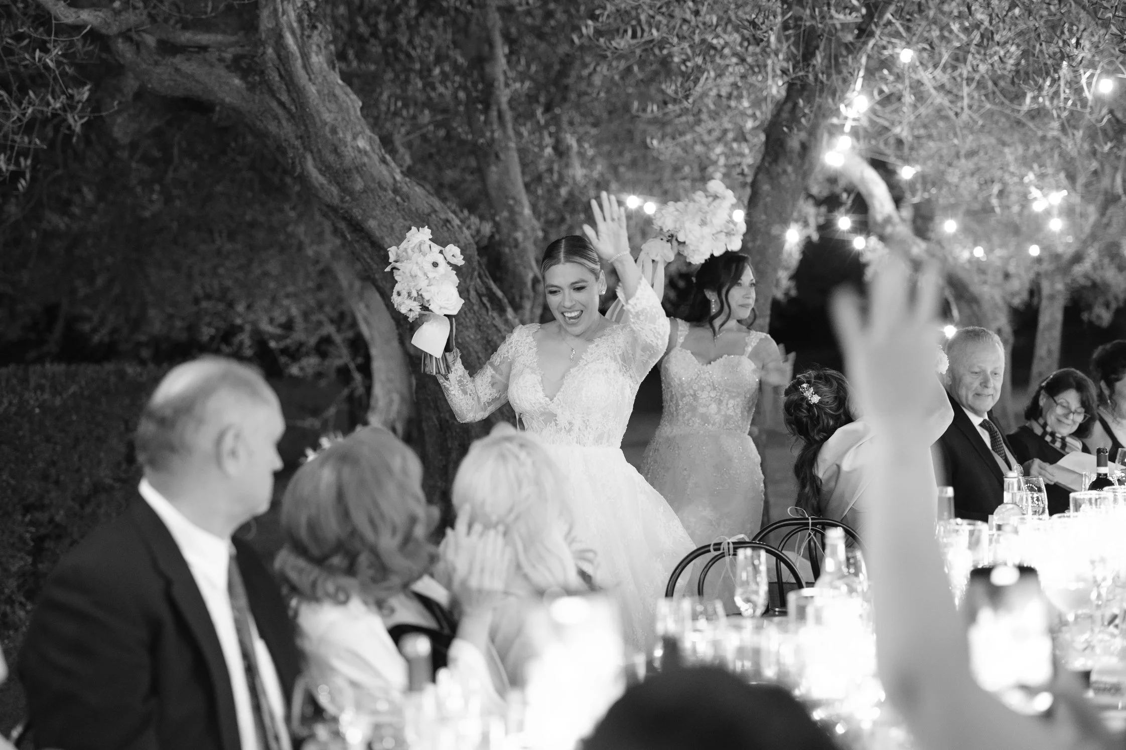 The brides enter the reception , al fresco dinner at terre di nano in the olive groves