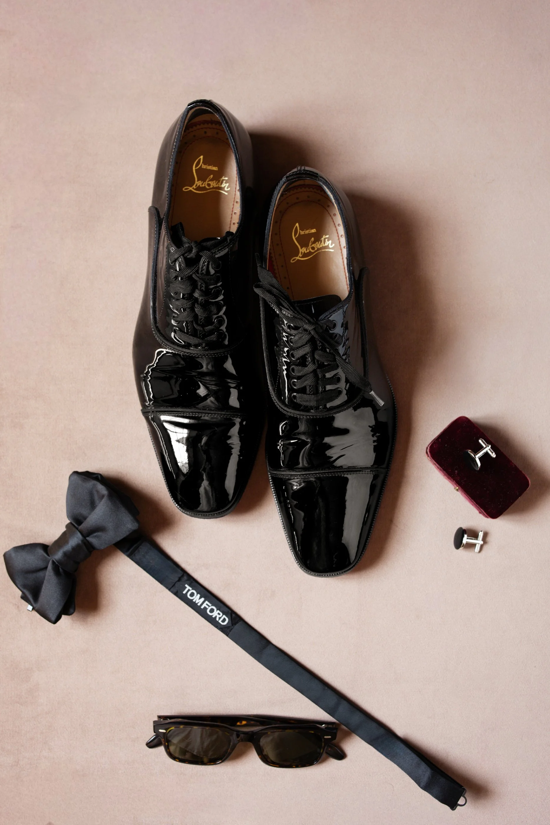 Wedding details including Christian Louboutin shoes, bow tie and cufflinks