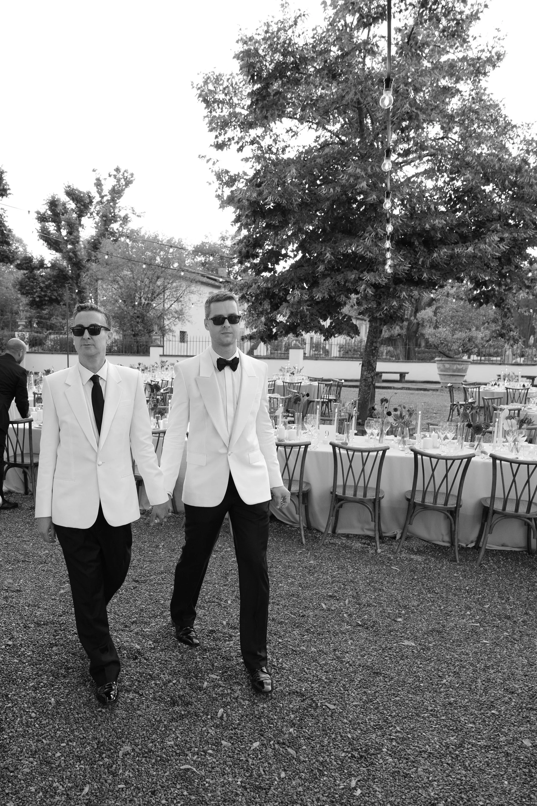 The couple arriving at their elegant outdoor reception