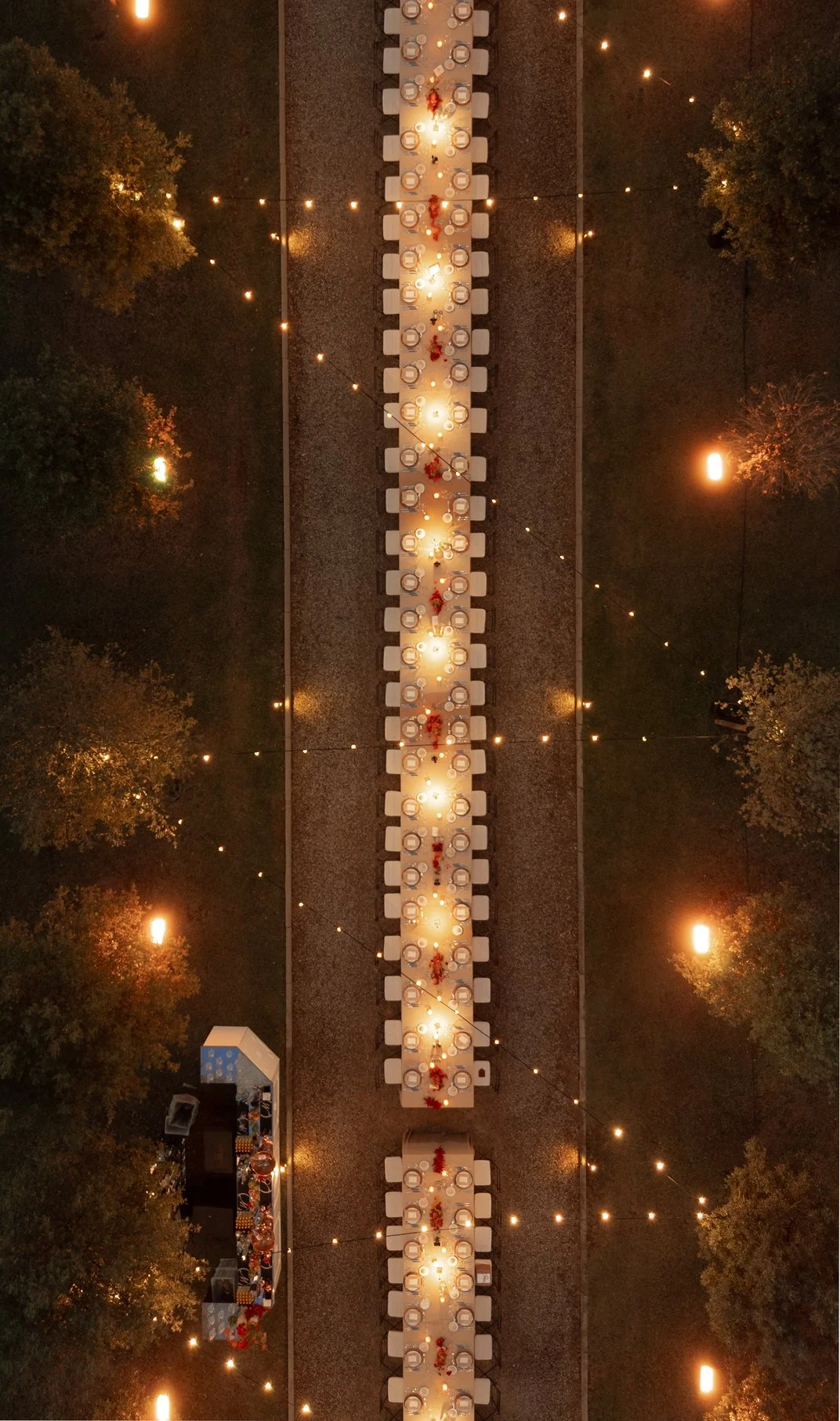 Aerial view of the candlelit dinner table at Il Borro after sunset
