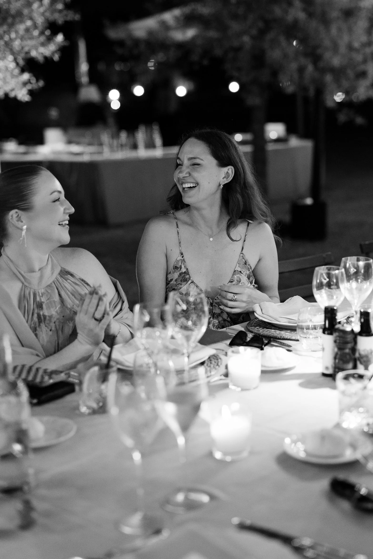 Guests laughing together during the welcome dinner in Tuscany