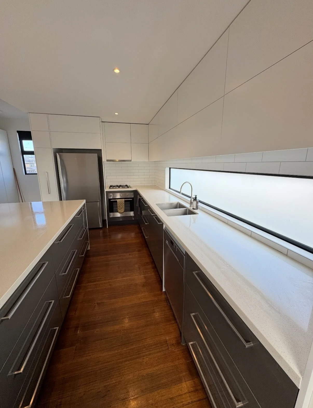 This transformation has completely brightened the space, showing that sometimes all it takes is a facelift to make a kitchen feel brand new.

We installed new overhead kitchen doors, end panels, splashback and a sink mixer. Keeping the costs down but