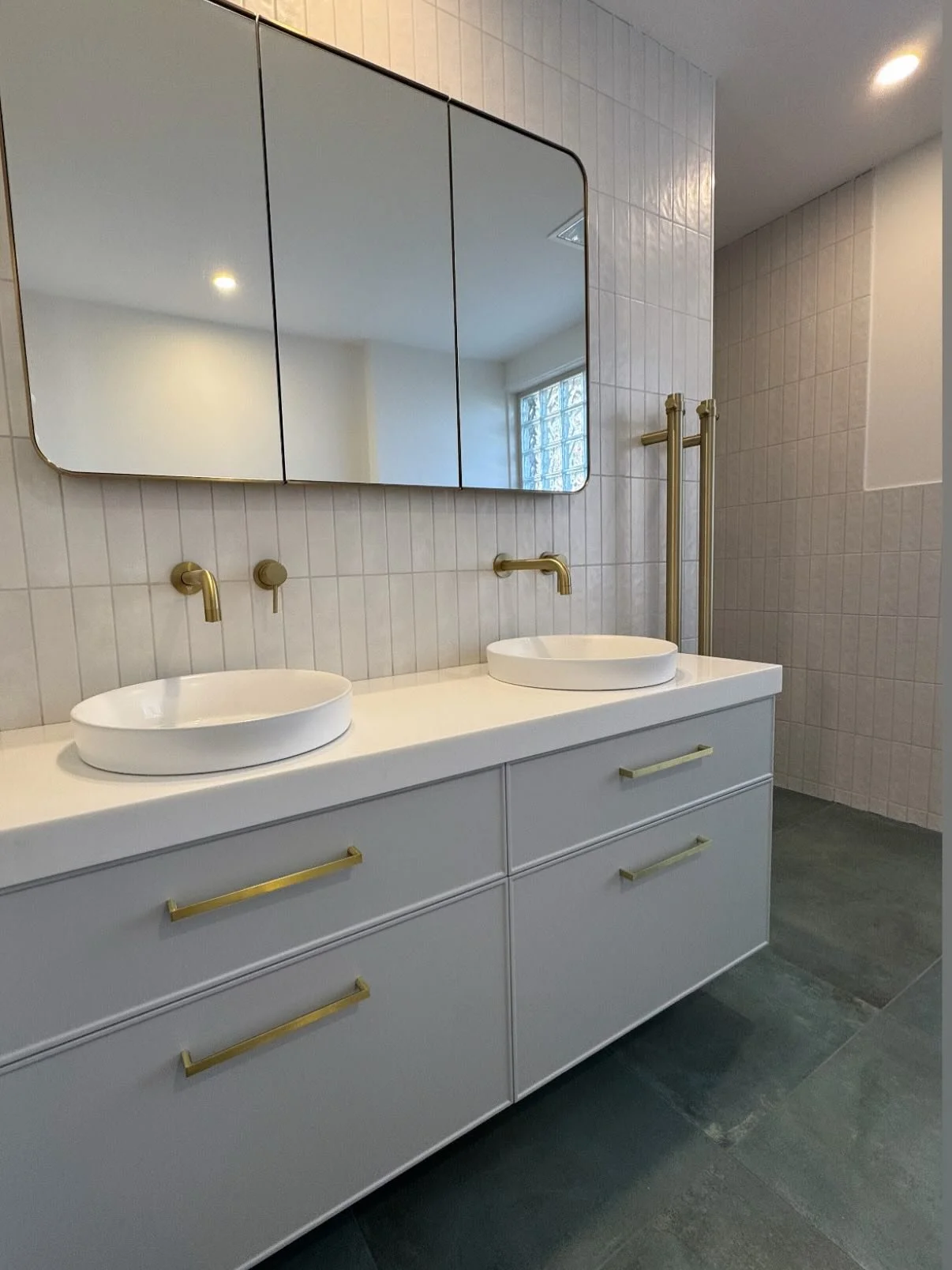 This bathroom transformation is one of our favourites yet. 

We kept the glass block window to let in soft natural light, then paired it with fresh tiling, brass fittings, and a modern layout to really change the feel of this bathroom. 
⁠
#frankstons