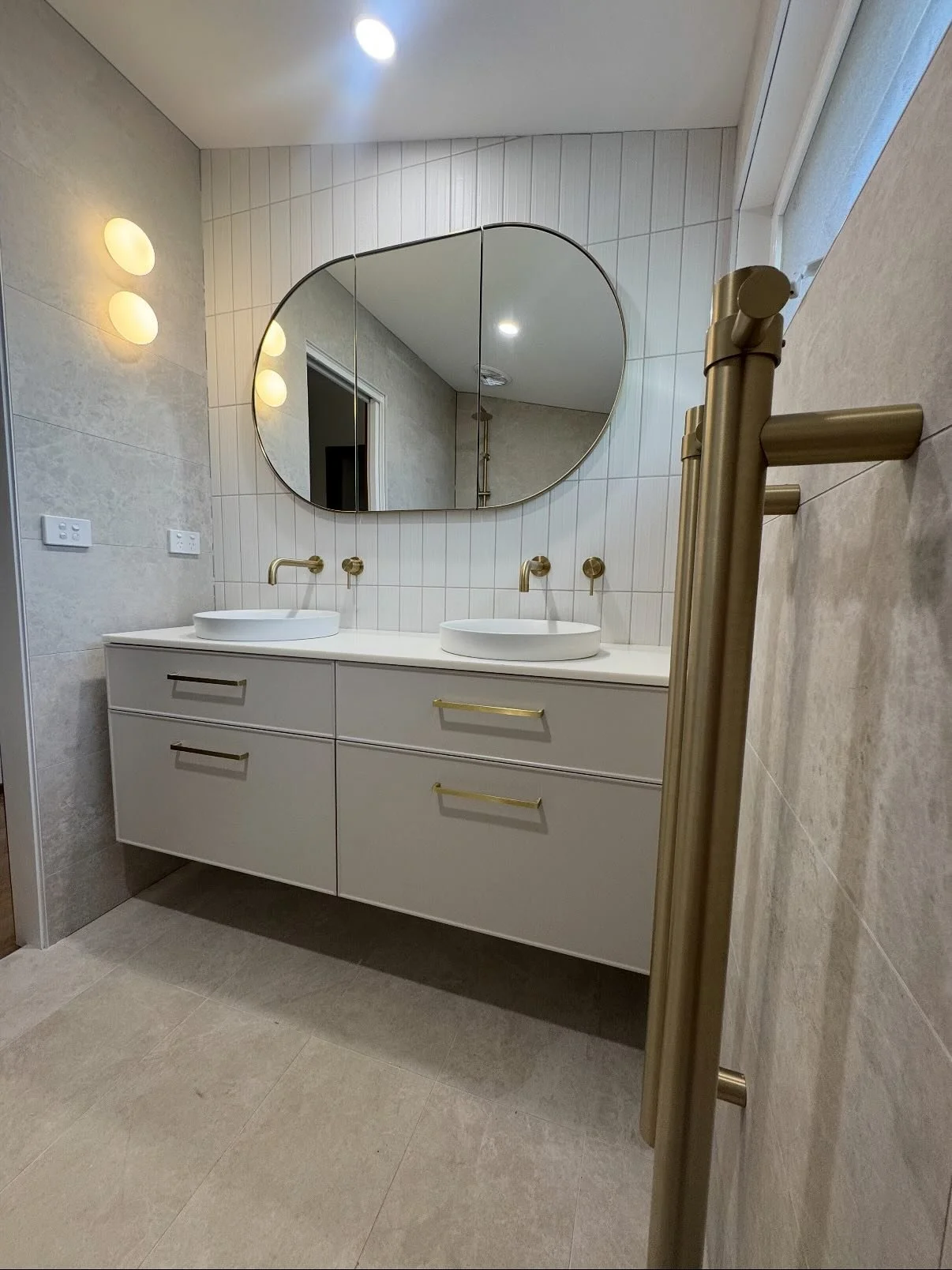 What a transformation! We took this outdated, cramped bathroom and completely reimagined the space with:

&bull; A brand new walk-in shower with sleek curved glass and brushed gold fittings
&bull; A modern double vanity with vessel basins and stateme
