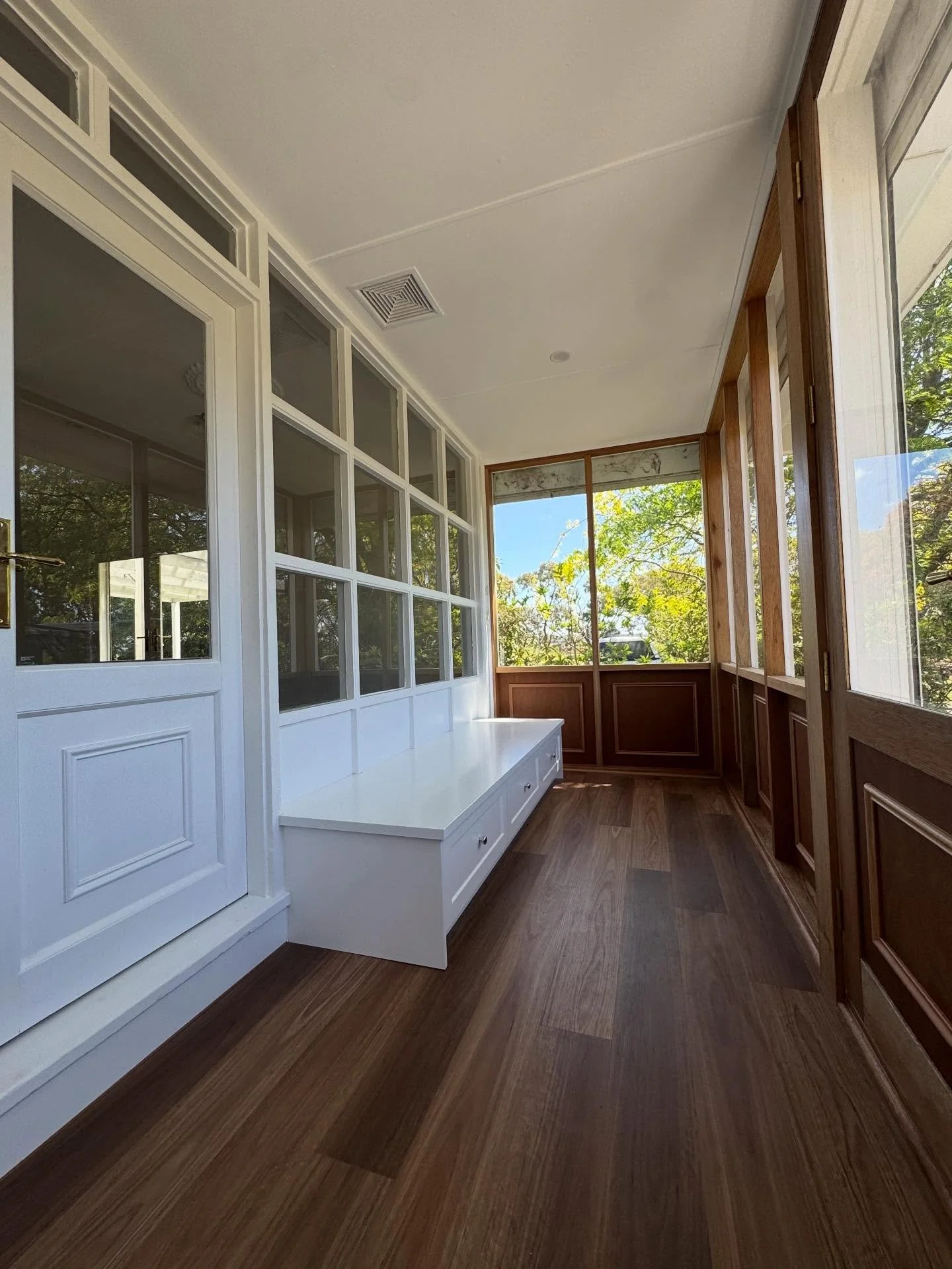A fresh take on a classic sunroom. 
New flooring, natural timber and clean white lines to brighten the entire home.