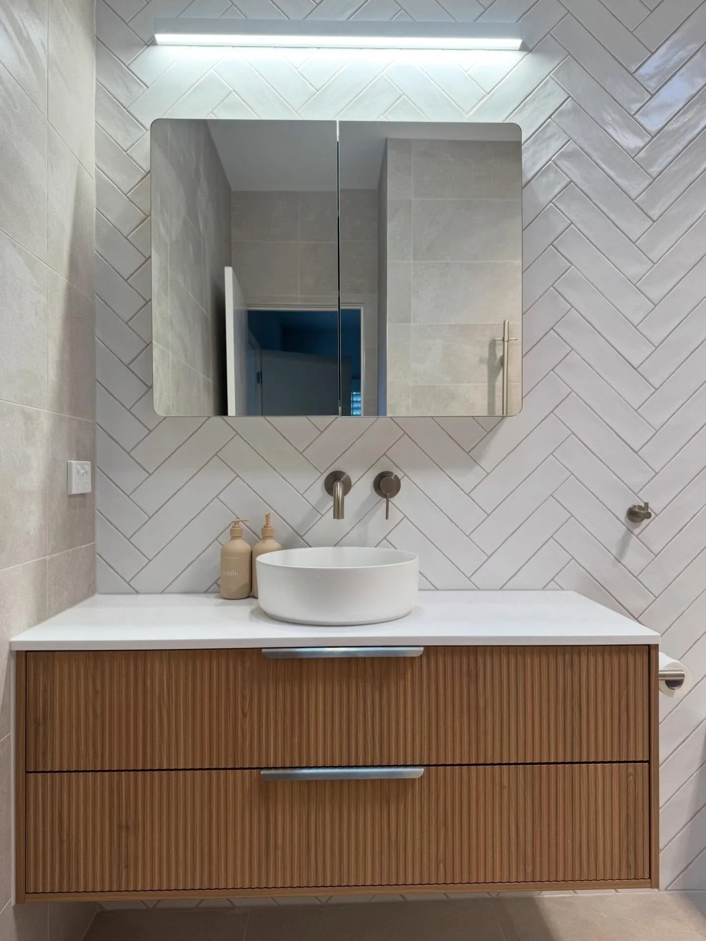 Ensuite renovation complete in Mount Eliza. 

A calm, contemporary space featuring herringbone wall tiles, custom timber vanity, stone benchtop and a seamless walk-in shower. 
Designed for everyday luxury with timeless finishes that won&rsquo;t date.