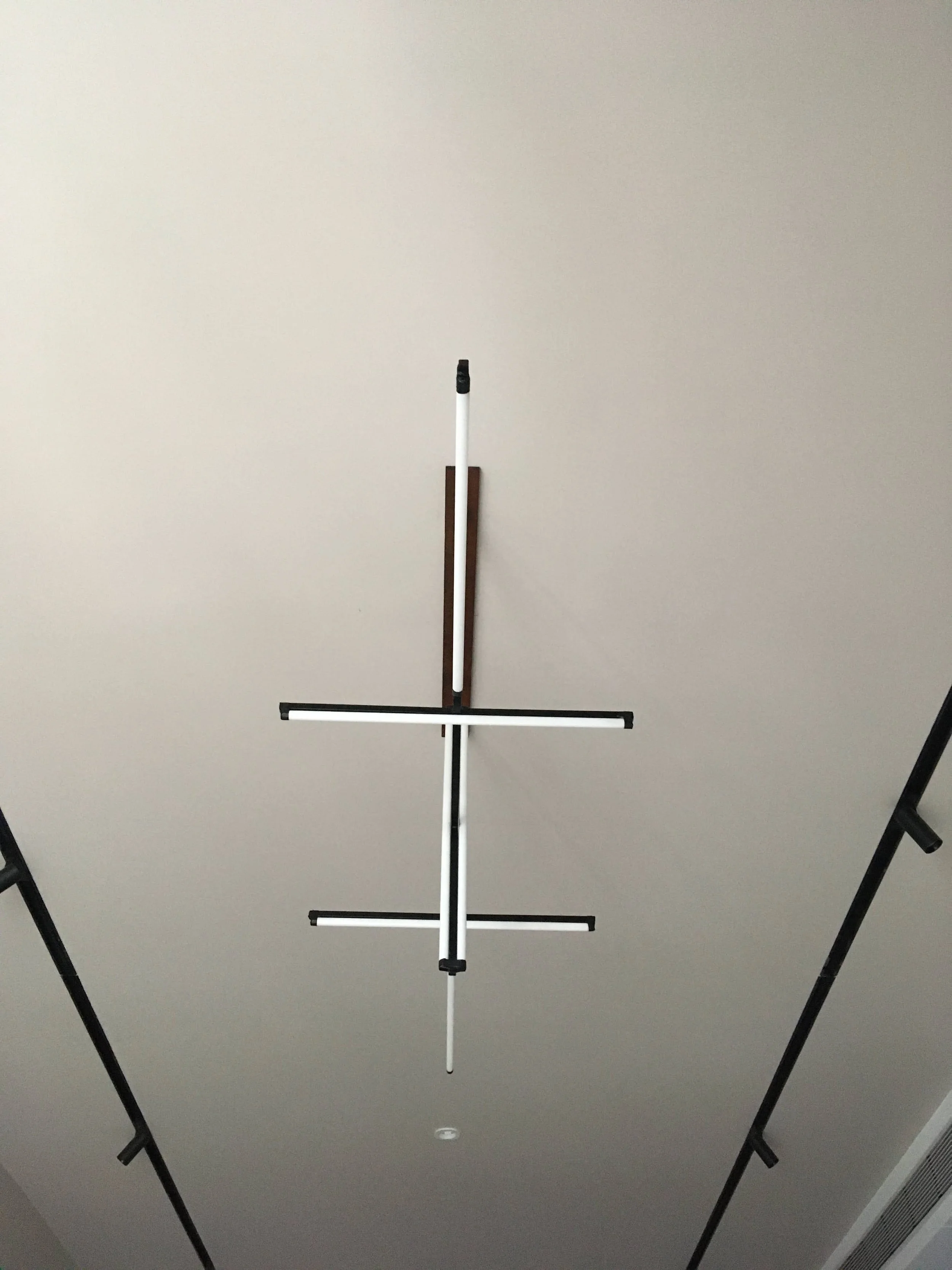 Ceiling with modern linear light fixture and track lighting