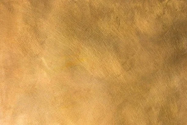 Gold textured background with a brushed metallic finish, conveying a luxurious and shiny appearance.