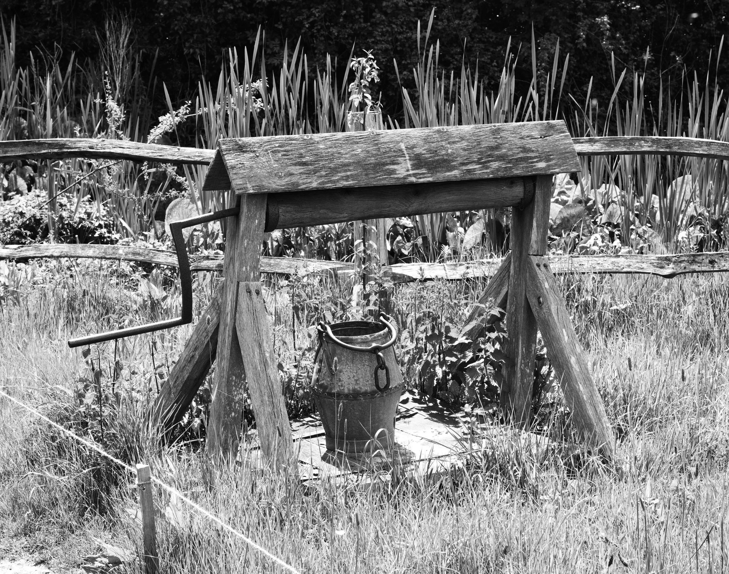 The well is dry, wishes fail, for water has the power. A reminder still it sits and bears the cross of time.