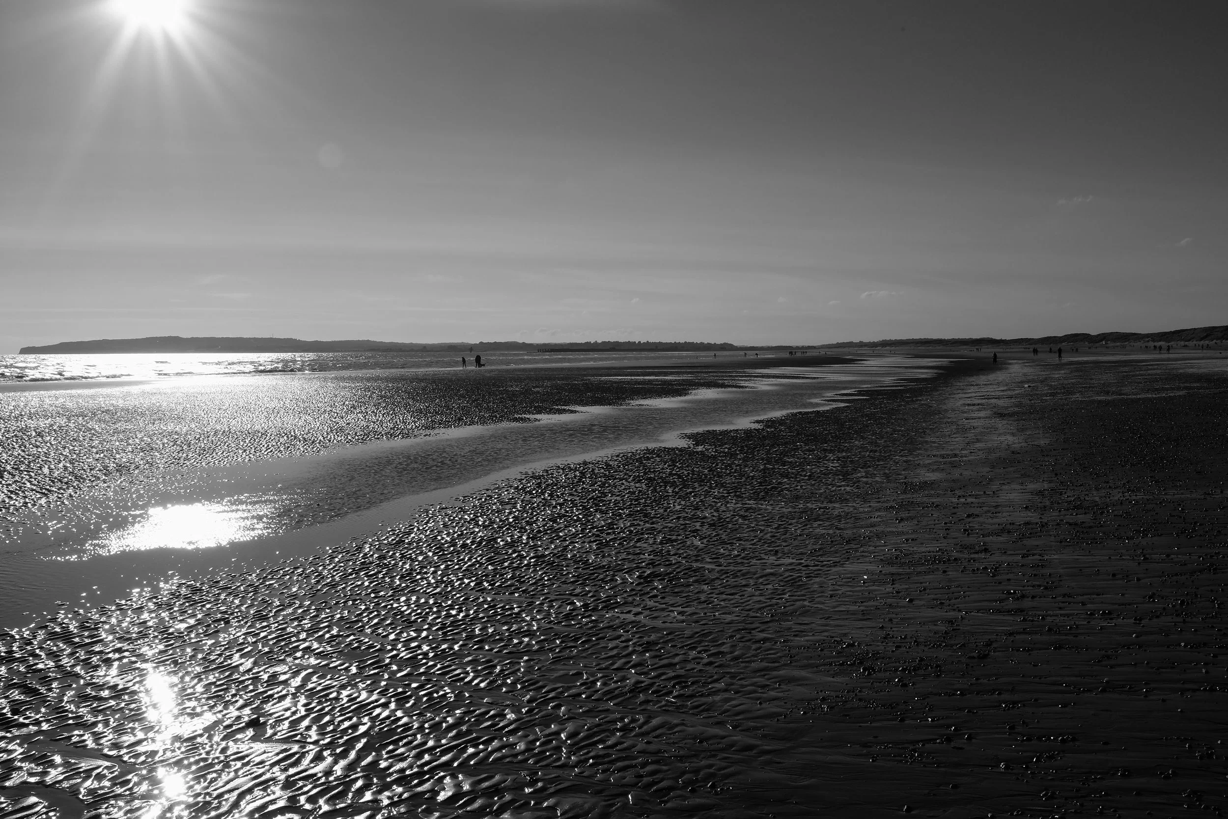 The touch on skin as breezes whisper, the sunlight glistens, reflects upon the waters glass. To walk upon the soft, to feel the life and live it.