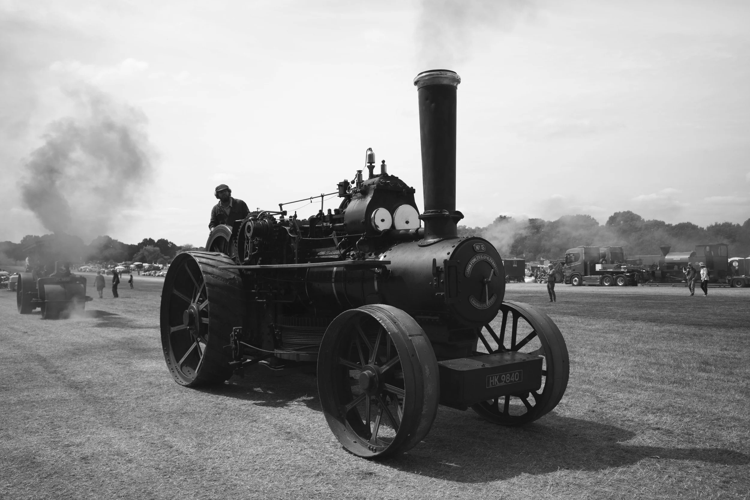 A summer fair, through history they hiss and clank to drive the corn and feed. To walk among machines of old rewards the smiles of being.