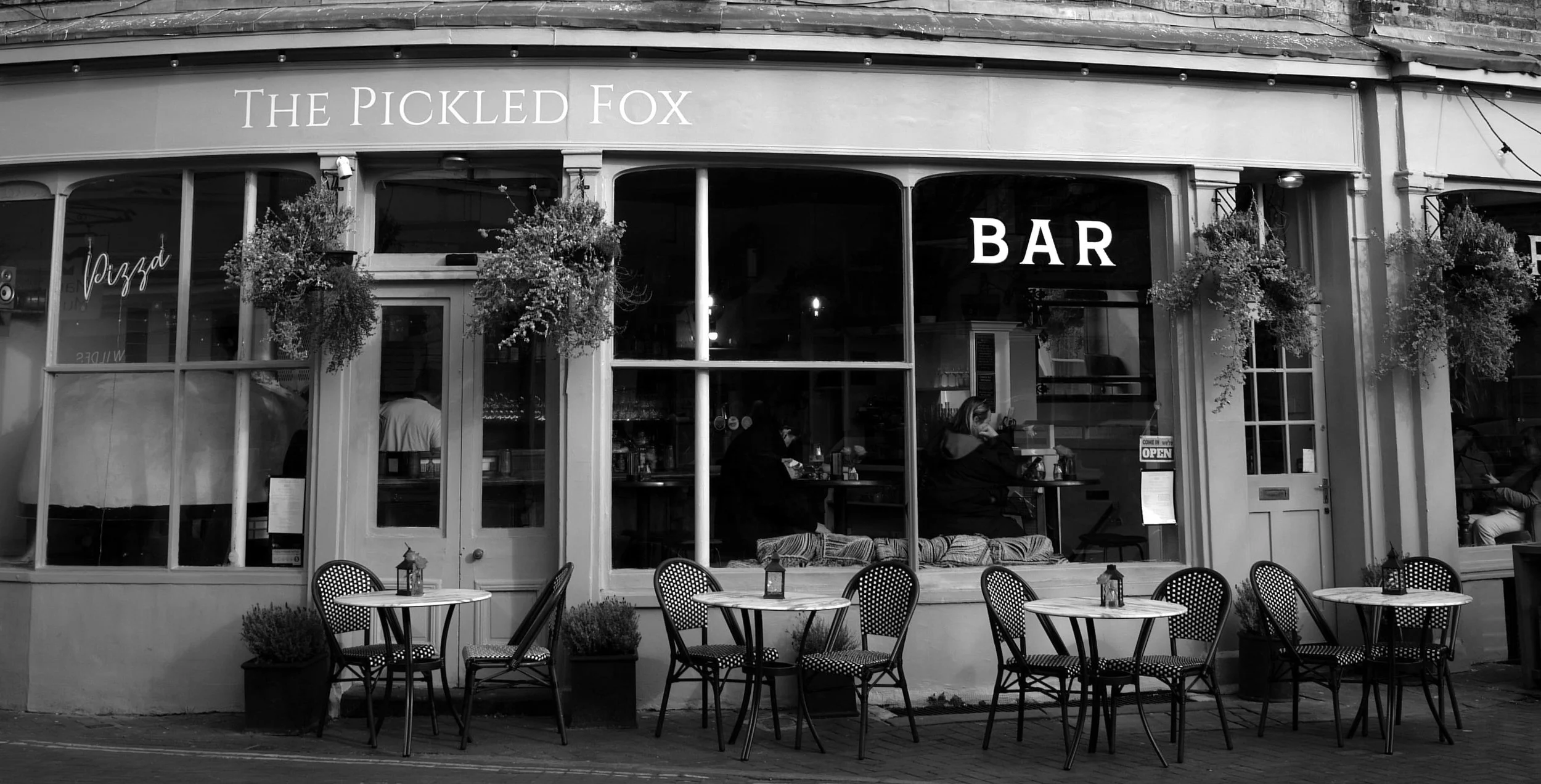 She sits and drinks, the distorted view through glass and spirit.