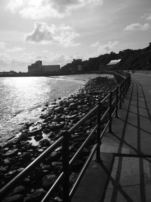 The sea does touch the stones, and greets them.