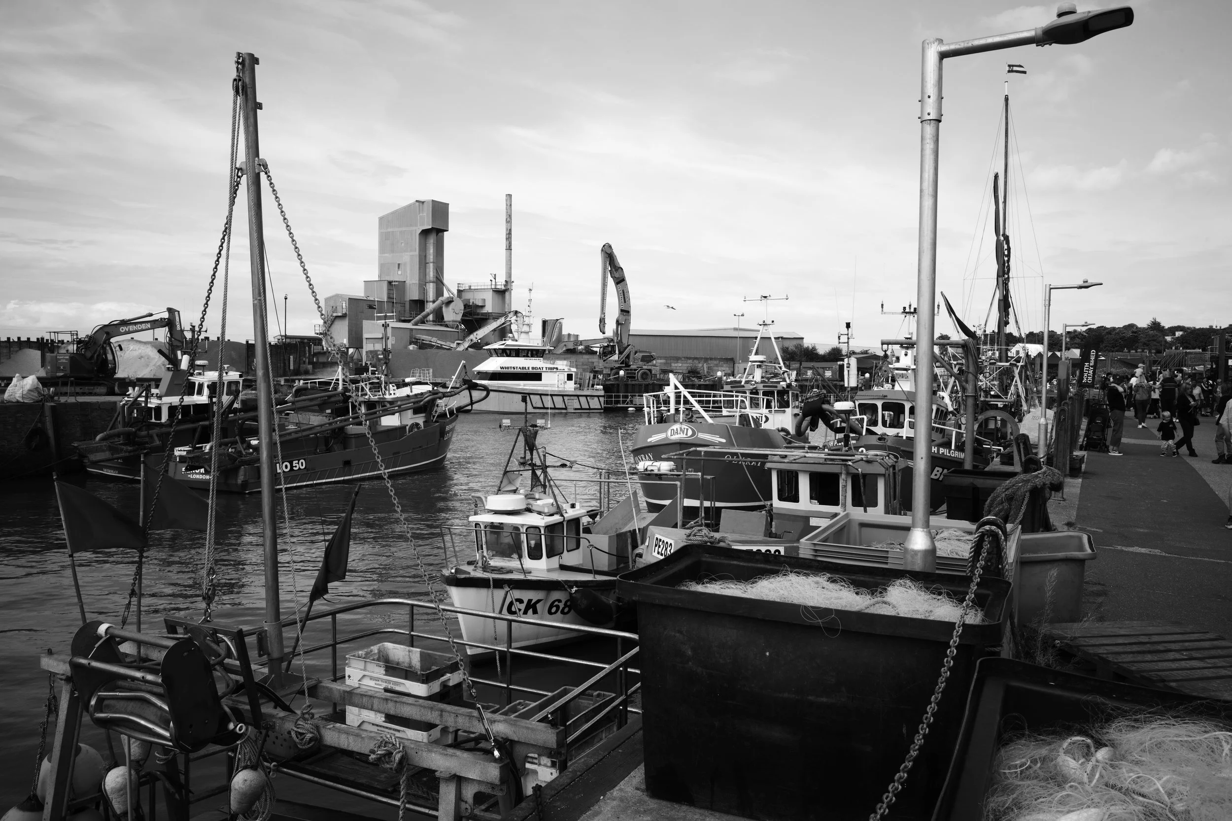 The clanks and whines of harbours toil, the busy keep it. To watch and see a life unfold.