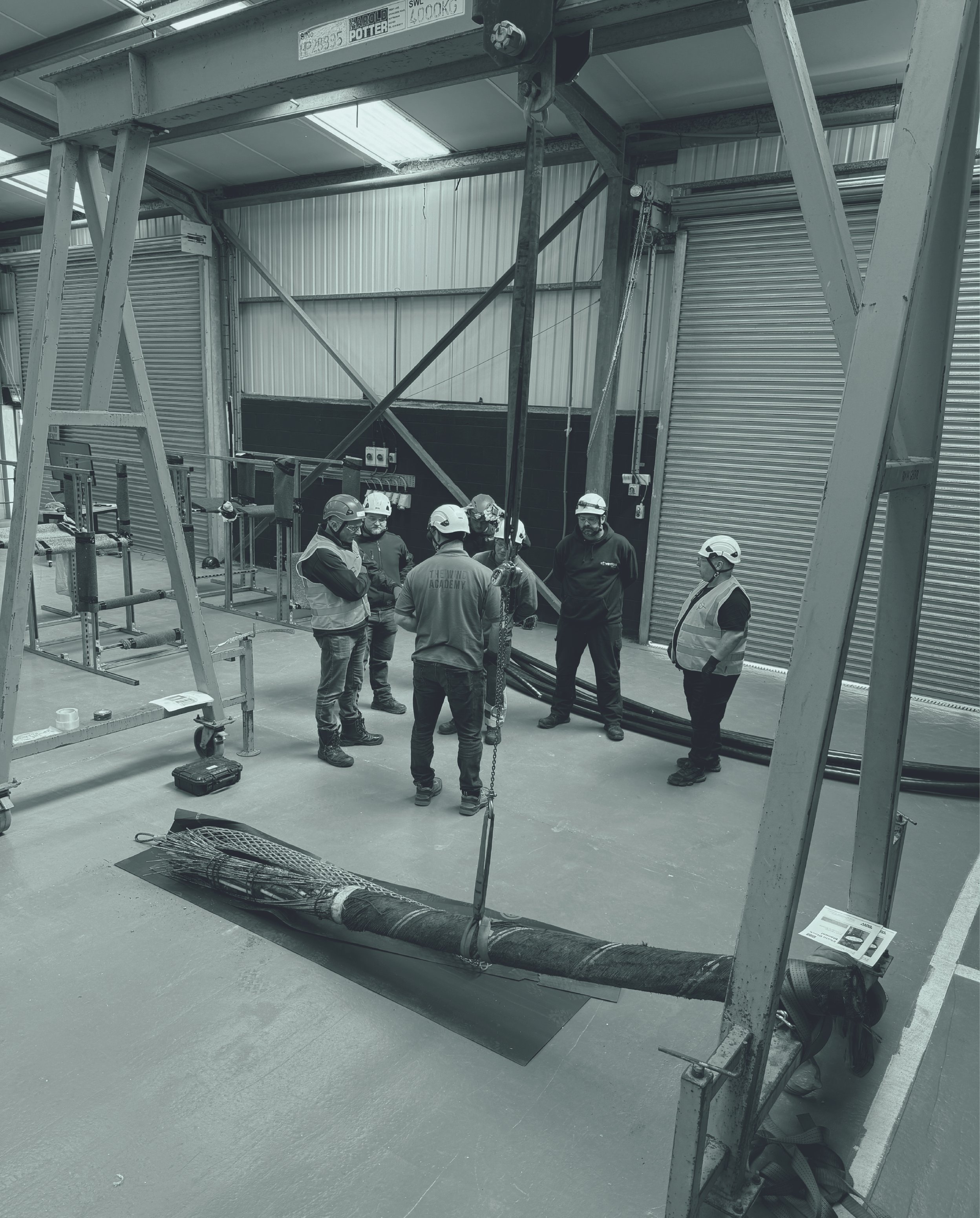 Seven workers in Safety equipment on the high voltage cable pulling course