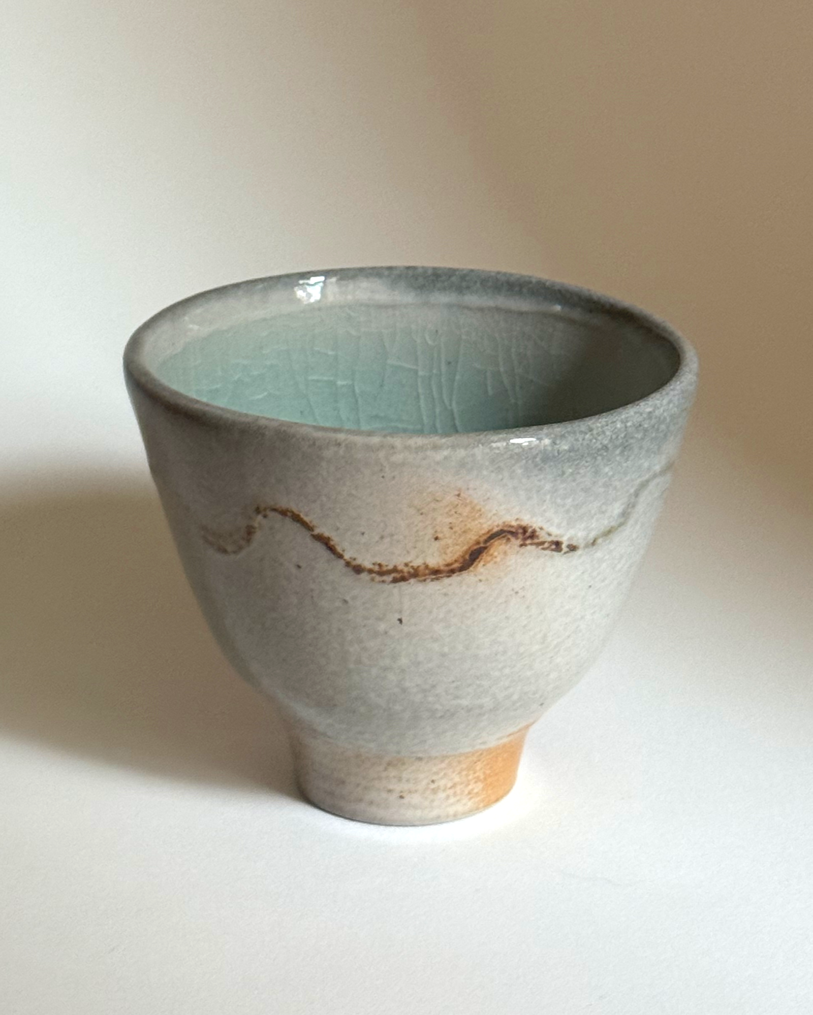 soda fired squiggle cup /
stoneware, copper oxide & reactive slip / 3"T x 2.5 W x 2.5 L