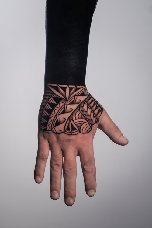 Authentic Polynesian hand tattoo by Mateusz at Skinzophrenic Tattoos Hereford