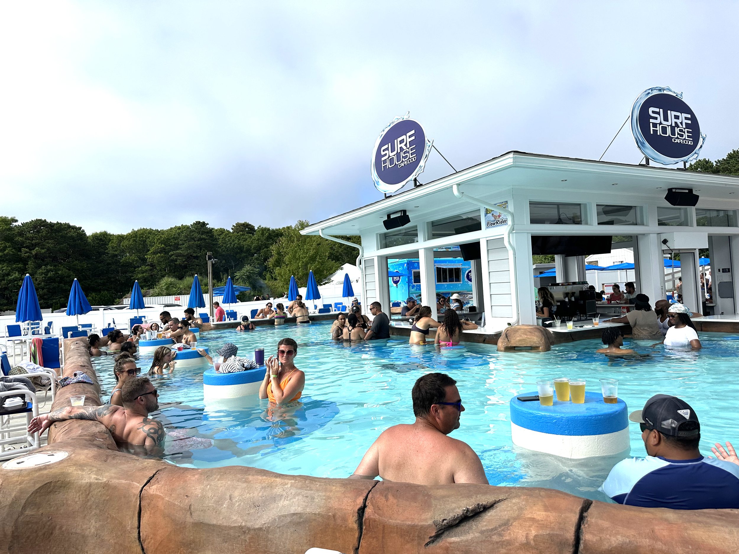 Visitors of the Wicked Waves Water Park enjoying a drink at the Surf House Pool Bar on Cape Cod