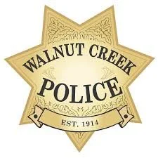 Walnut Creek Police badge with the words 'WALNUT CREEK POLICE' and 'EST. 1914' on a gold and beige shield-shaped emblem.