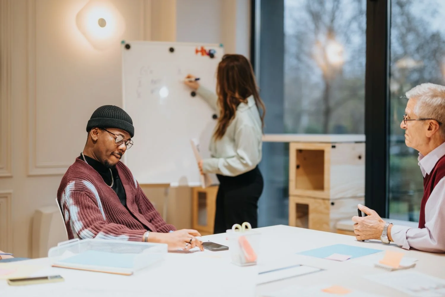 Women at whiteboard, men at table