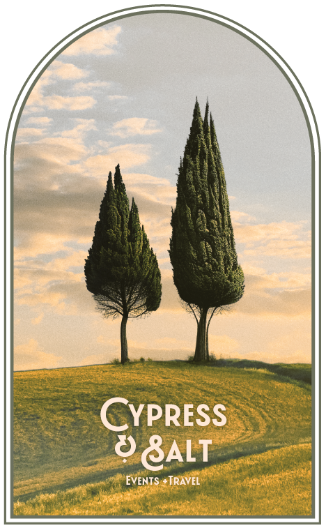 Two Cypress Trees Stand Tall in Field
