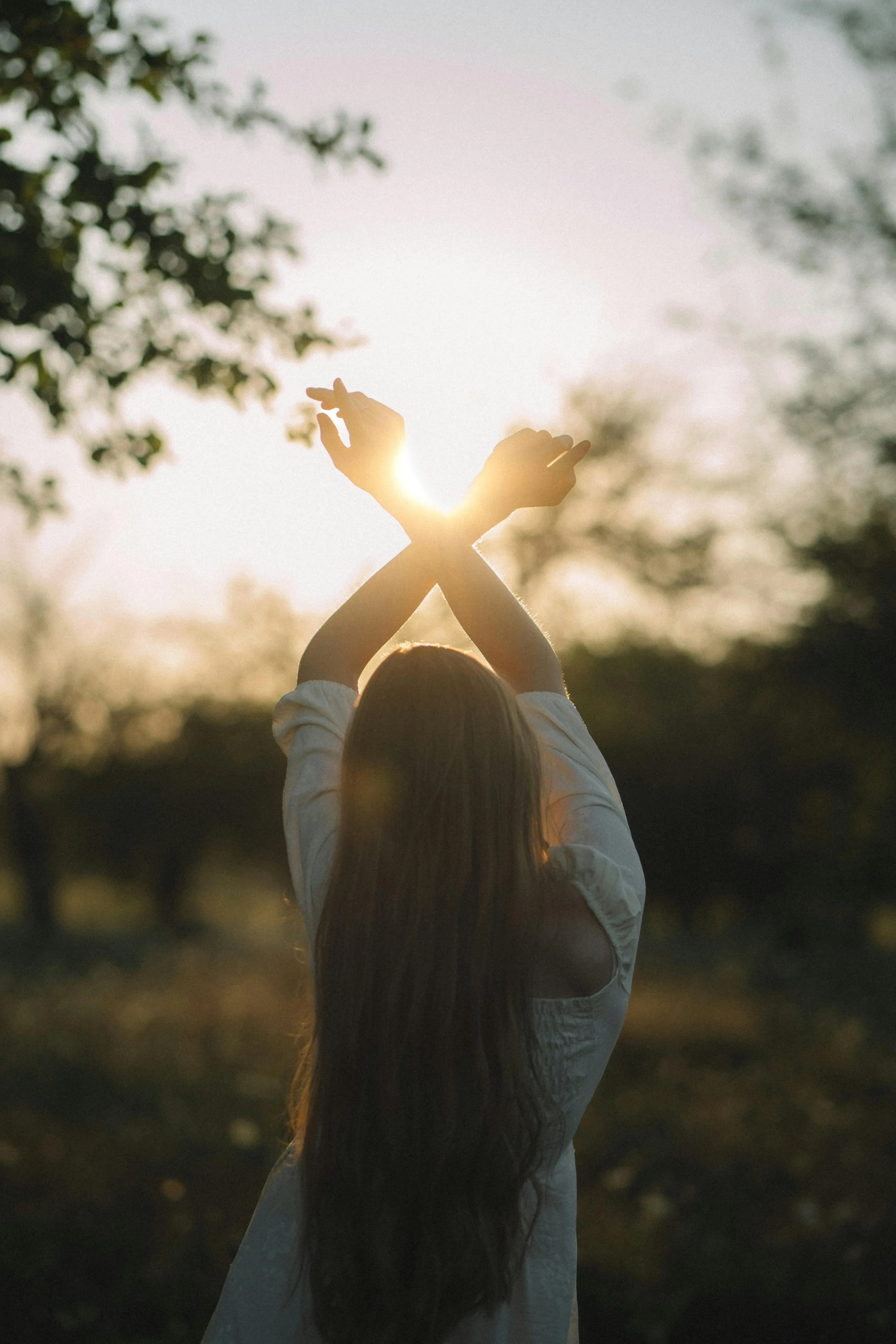 An image depicting a woman with long dark hair standing outdoors representing therapy for women and therapy for college students specializing in Anxiety Therapy, Trauma Therapy, Relationship Therapy, and Therapy for Narcissistic Abuse in Lansing, MI.