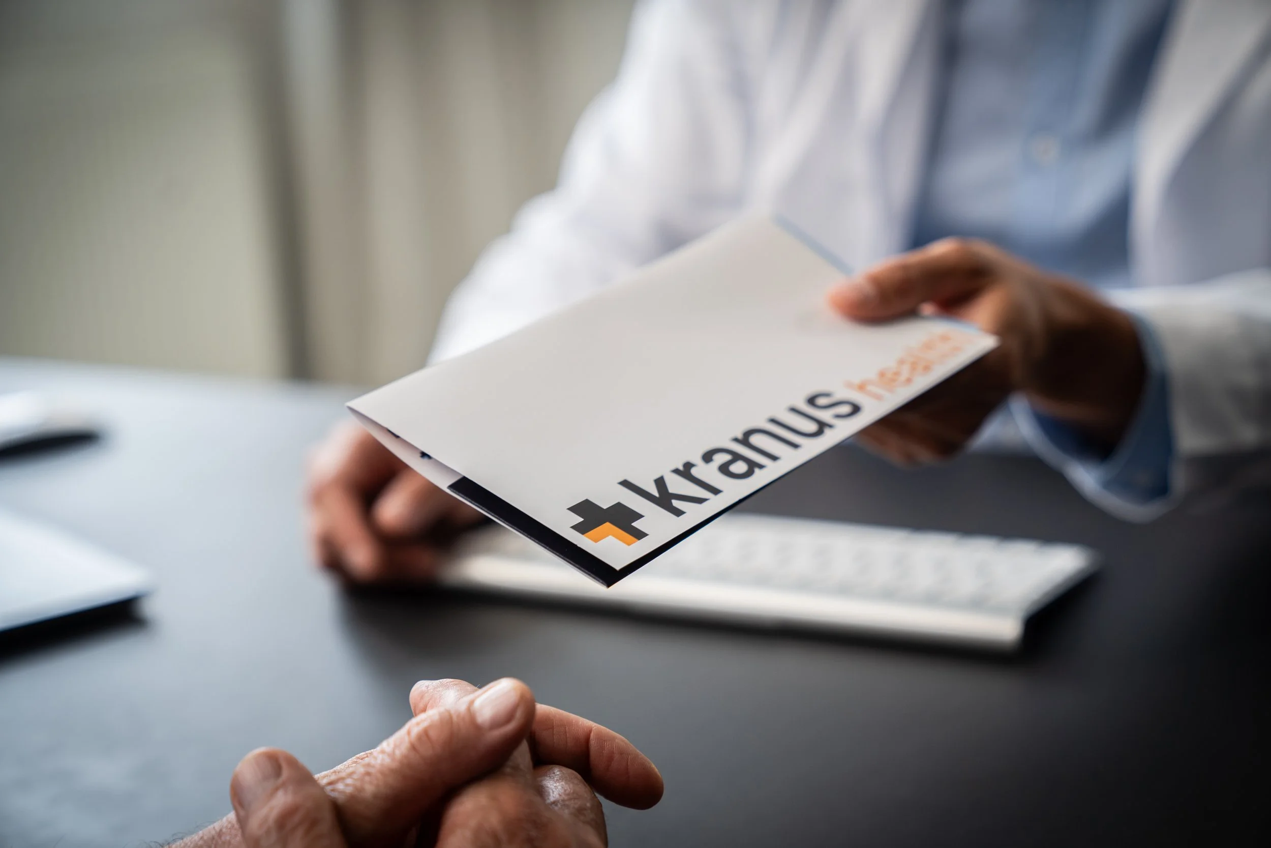 Doctor_Handing_Brochure1.jpg