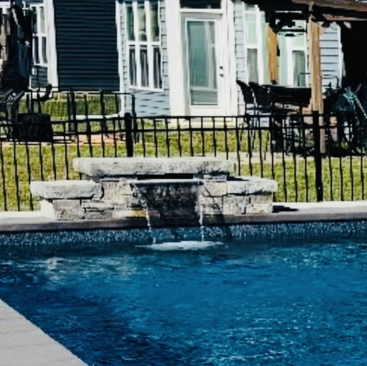 Stone waterfall feature on a custom inground pool built by Dale's Pools in Shepherdsville, KY. 