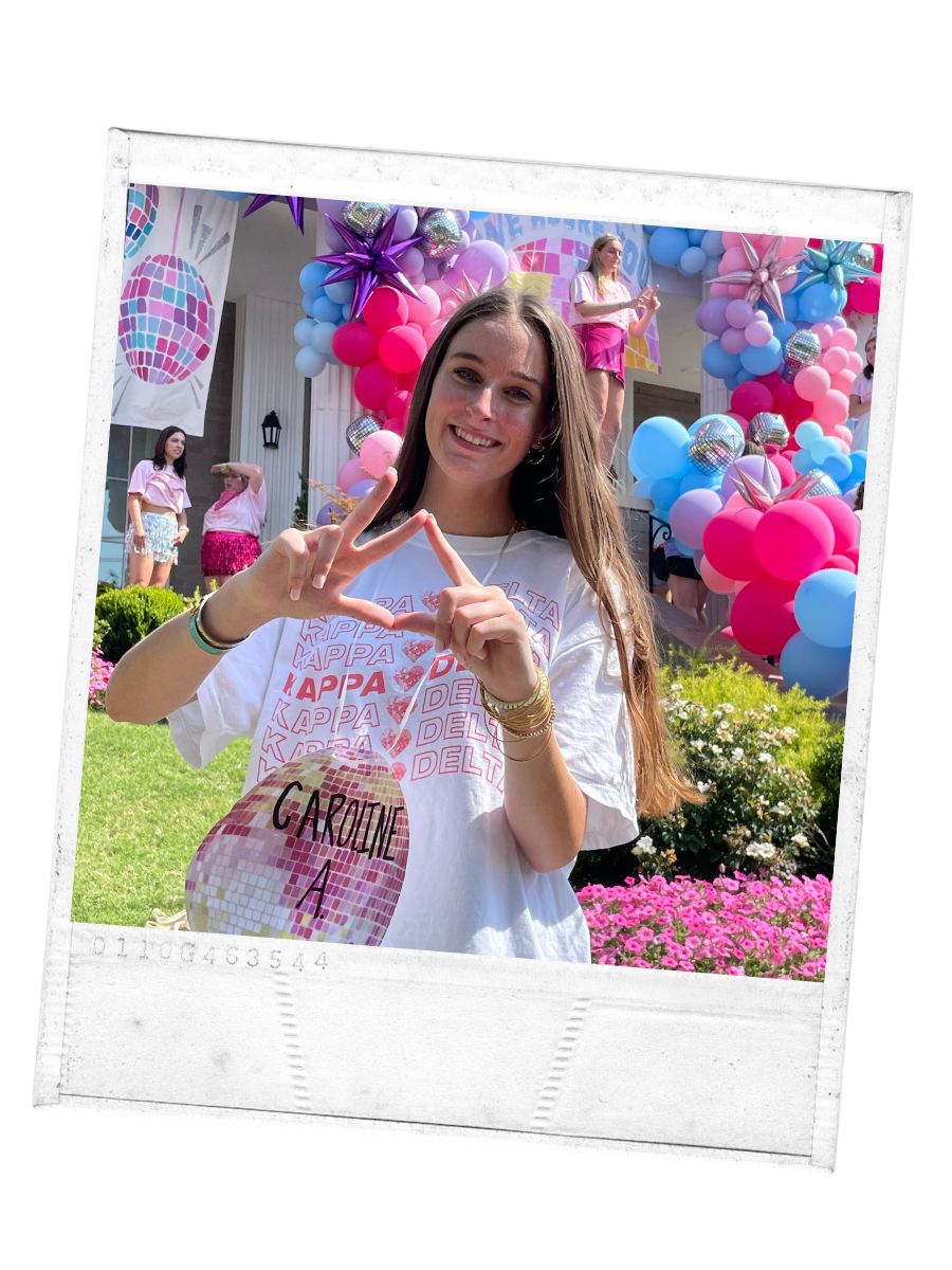 A girl in a white shirt gesturing her sorority house with her hands
