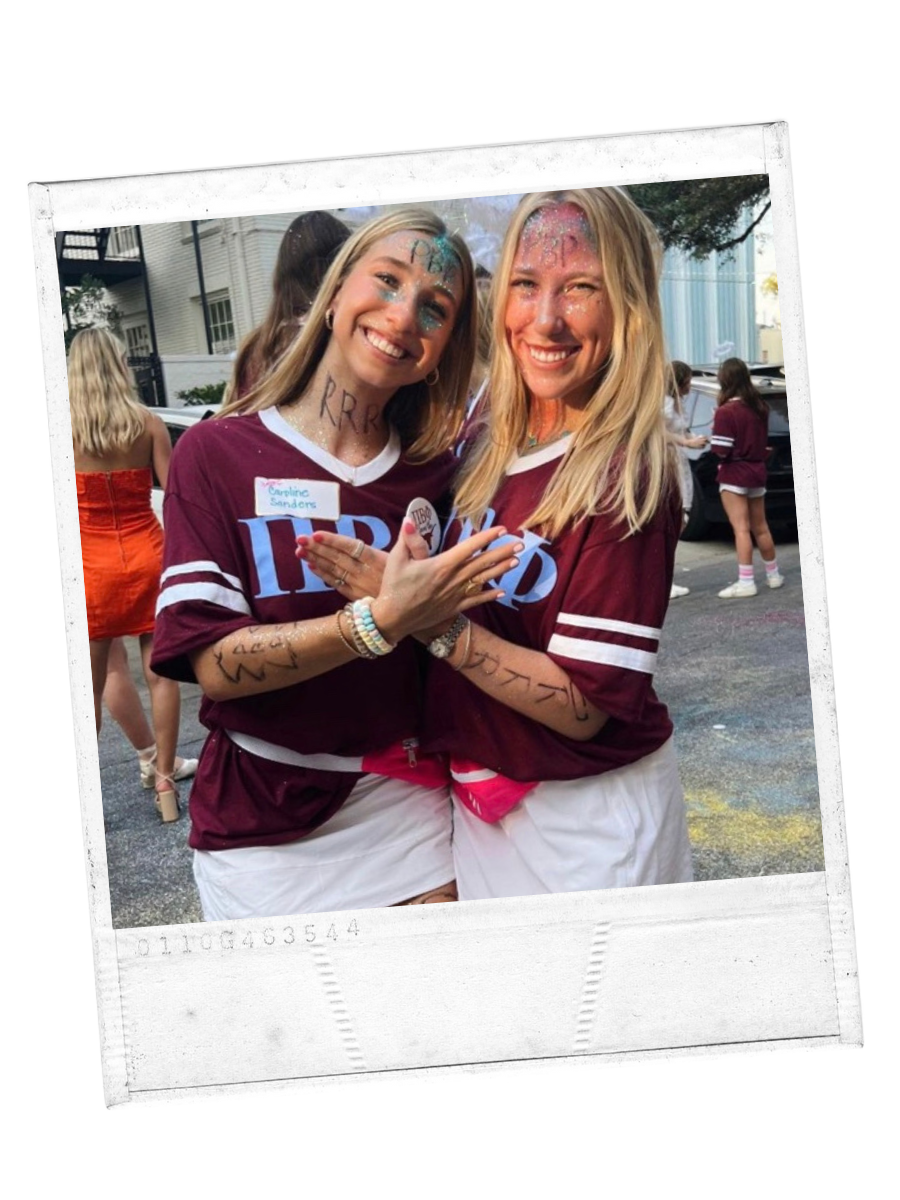 Two girls in maroon gesturing their sorority